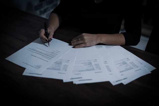 mulher assinando documentos que representa as alterações na legislação