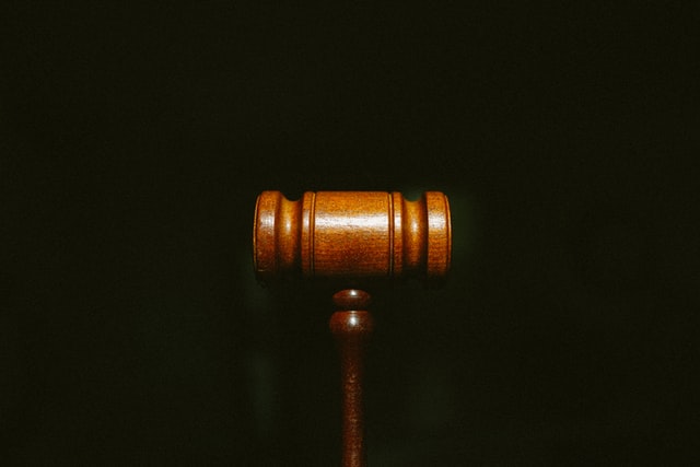A wooden gavel on a dark background
