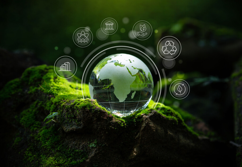 ESG. Globo do mundo com planta ao fundo e símbolos de sustentabilidade.